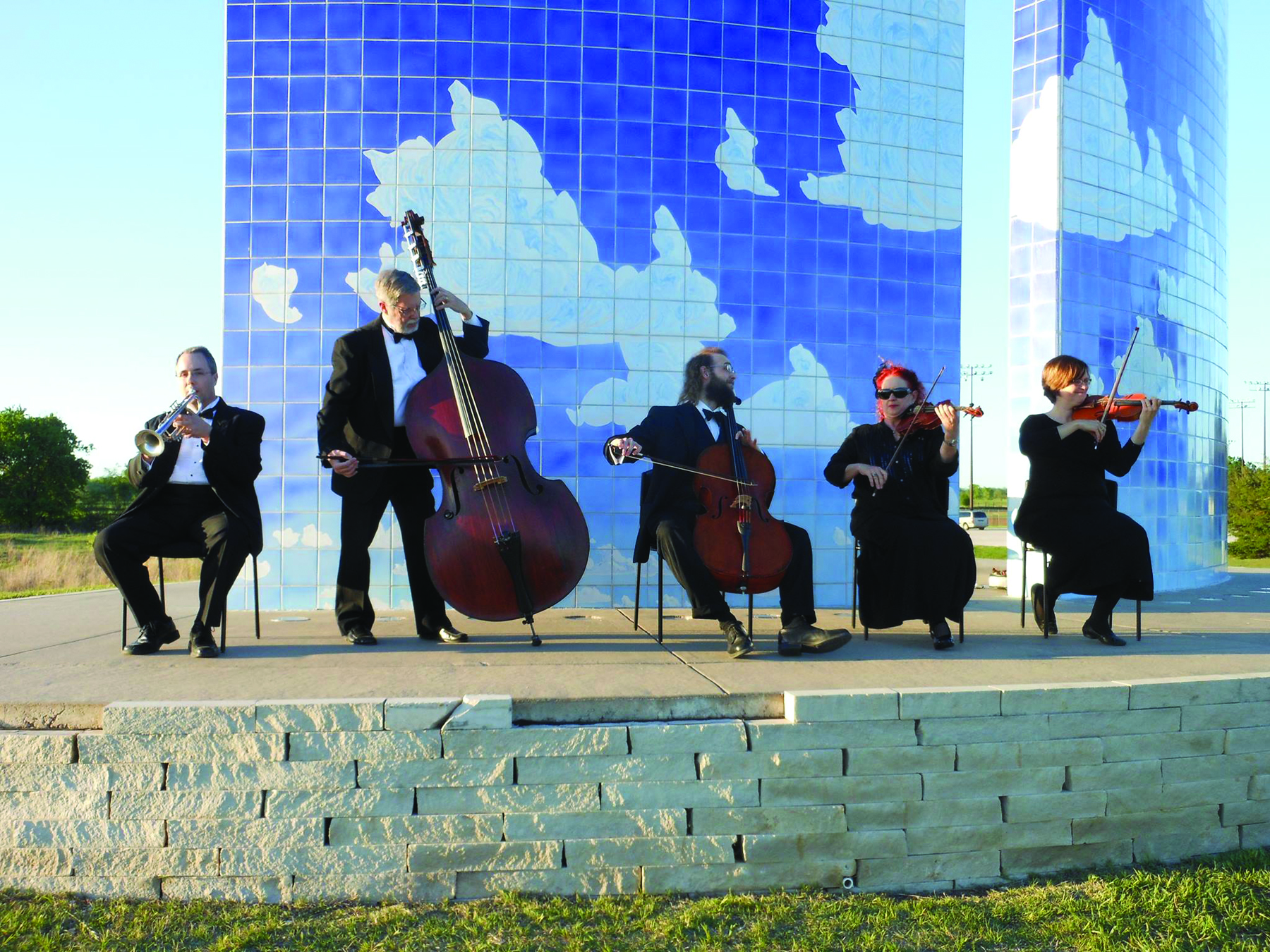 String quartet plays in front of the Blue Sky Sculpture