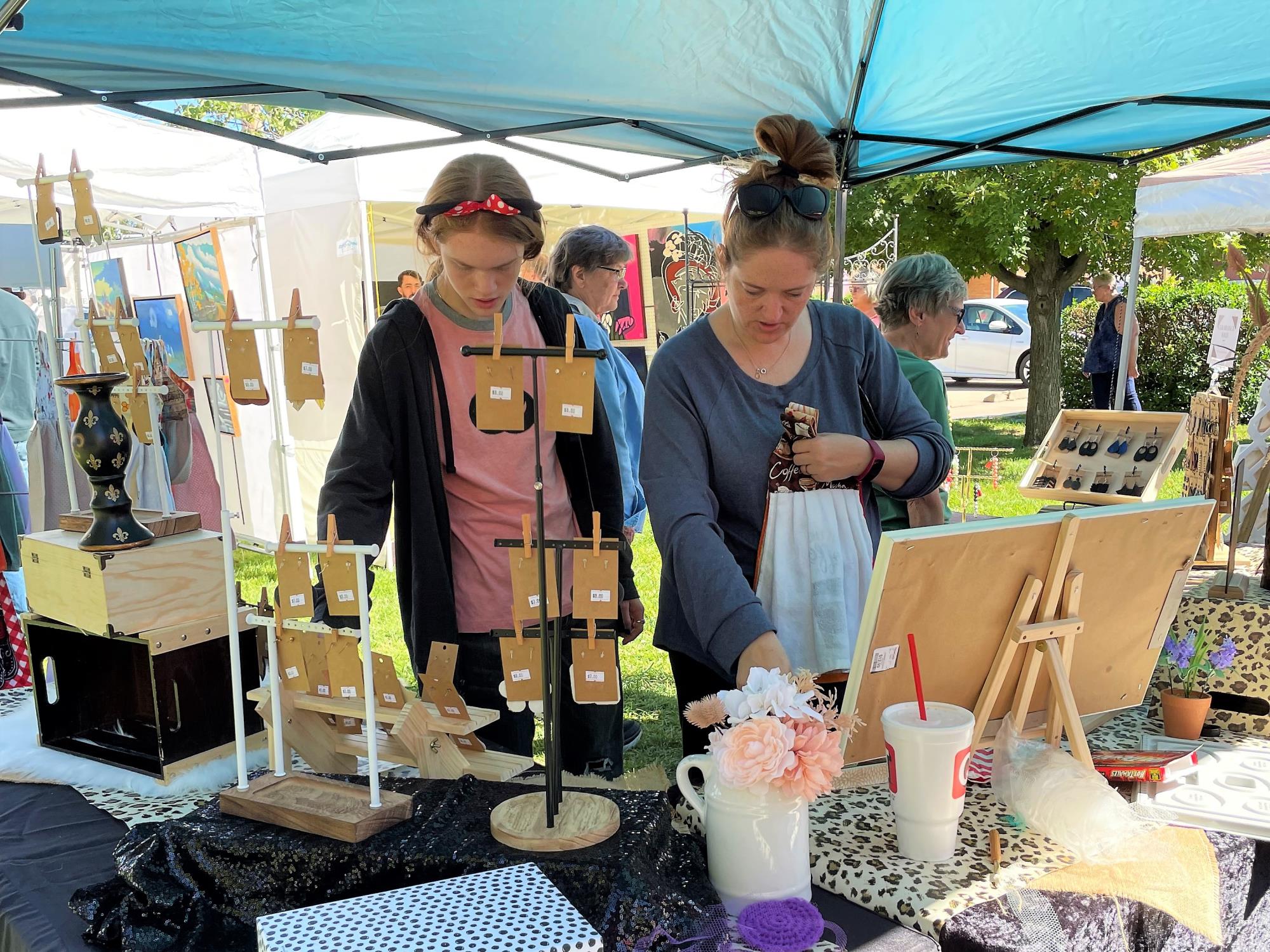 Two people shop at Art Market